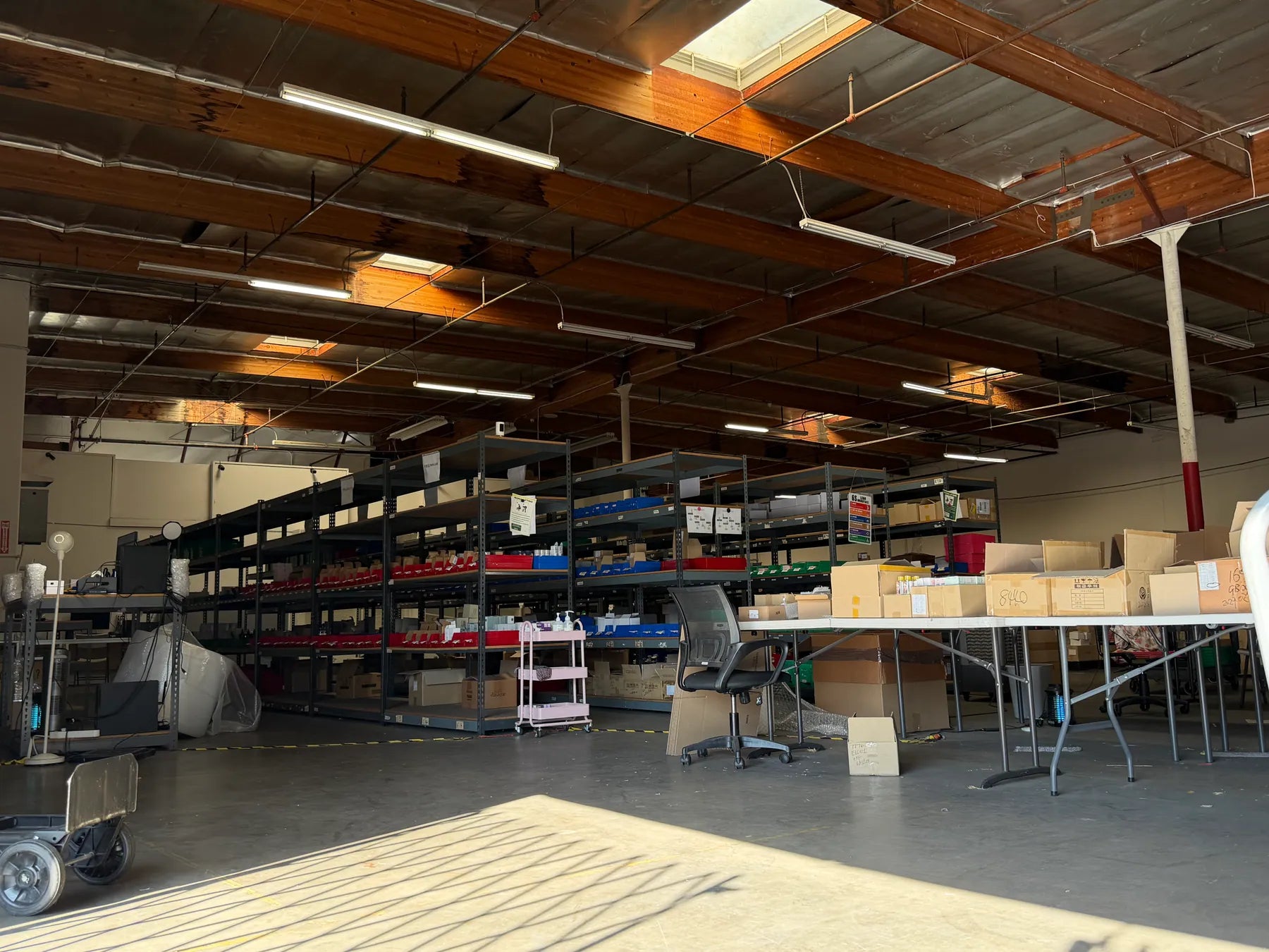 Yola warehouse with product shelving and packing workstations