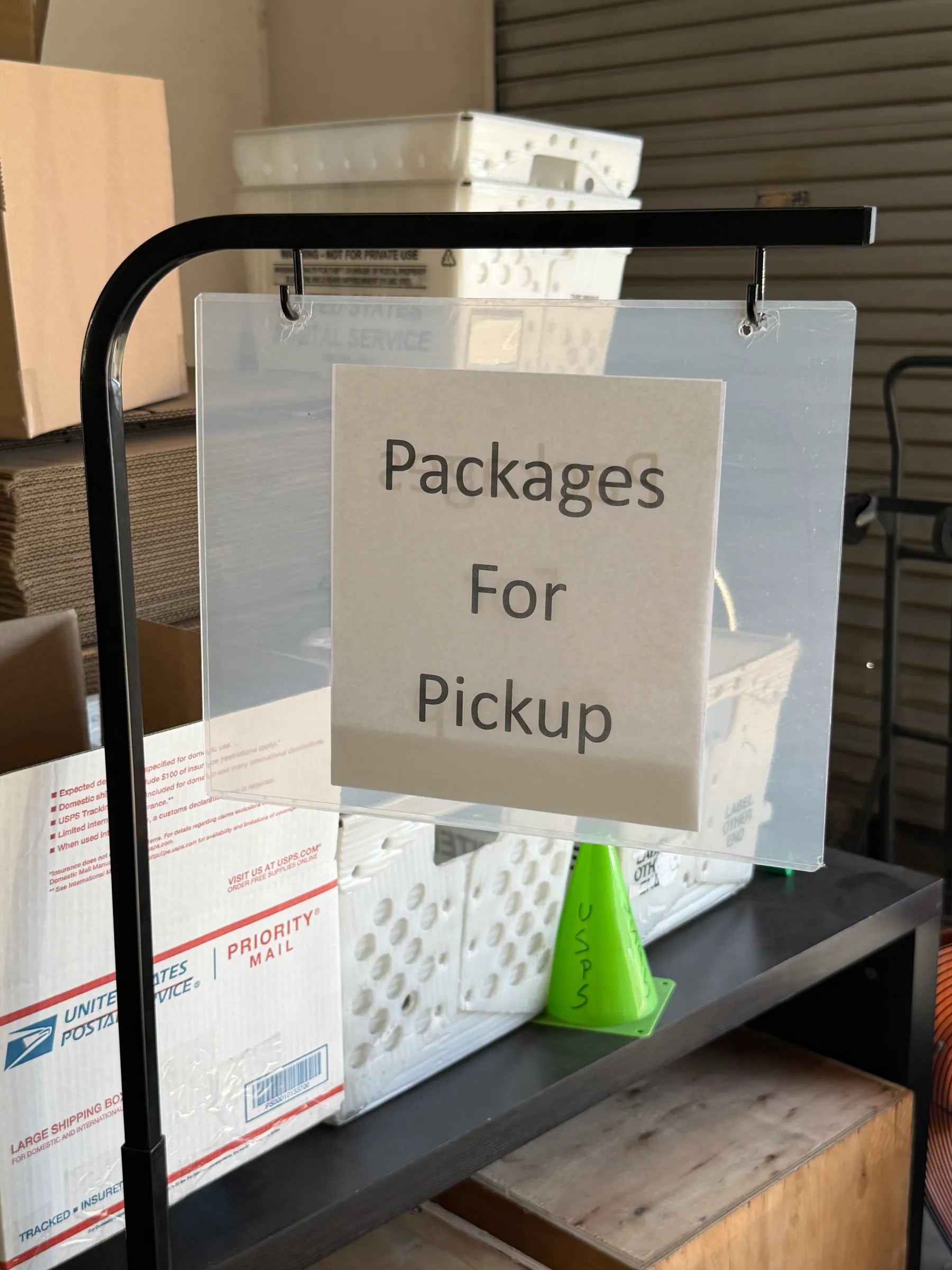 Packages for pickup sign beside shipping supplies