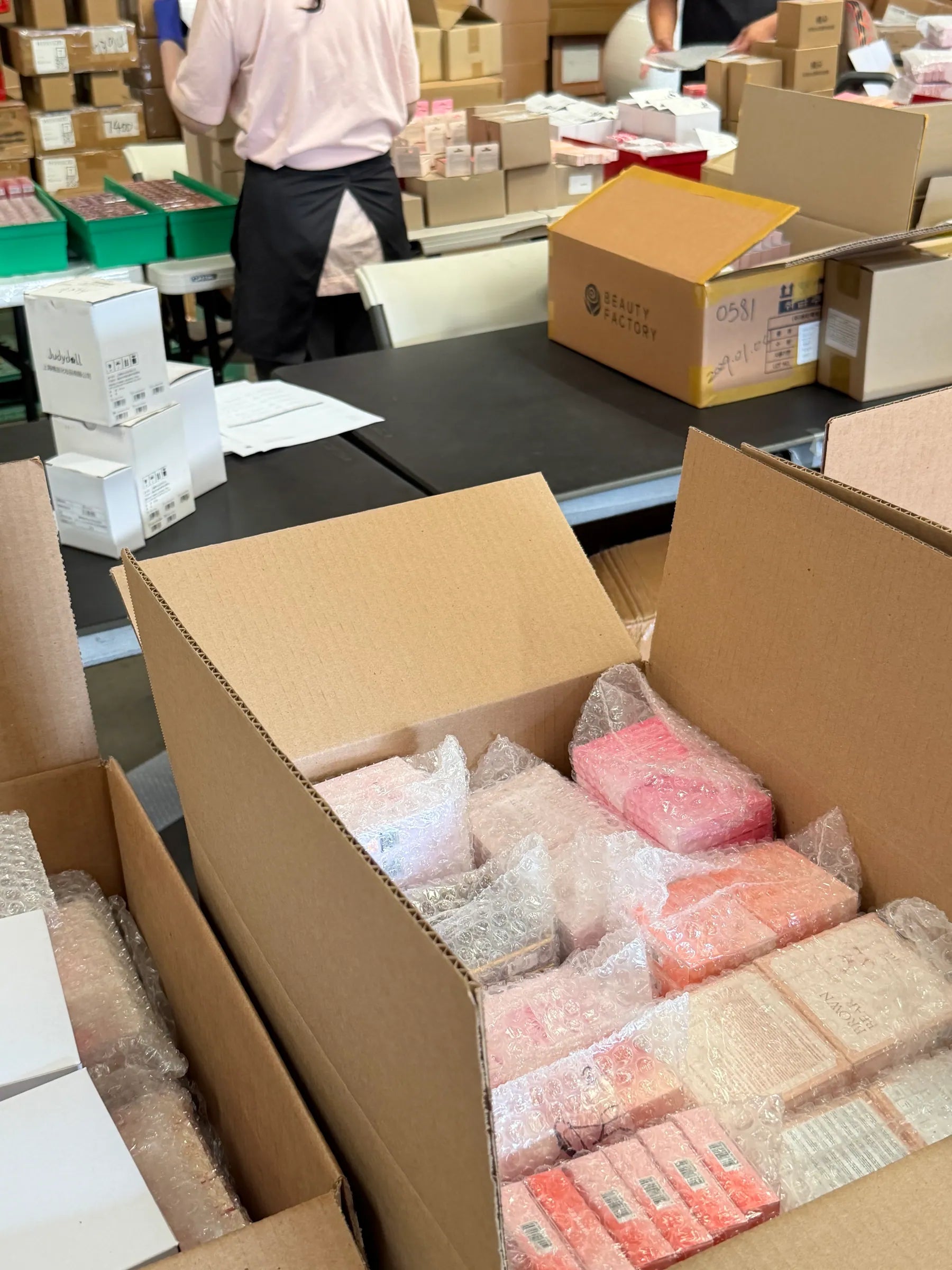 Beauty products wrapped and packed into shipping boxes