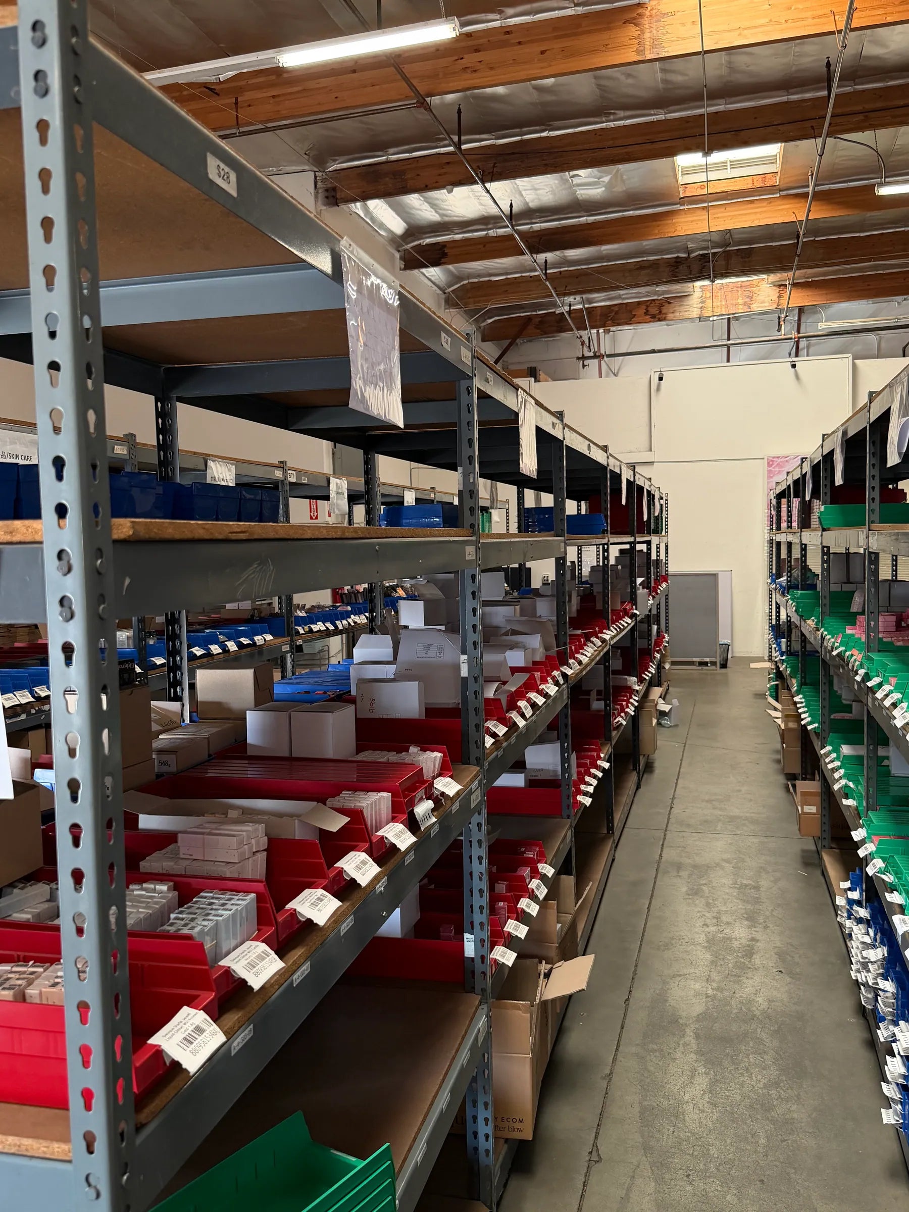 An aisle of organized beauty product storage at Yola