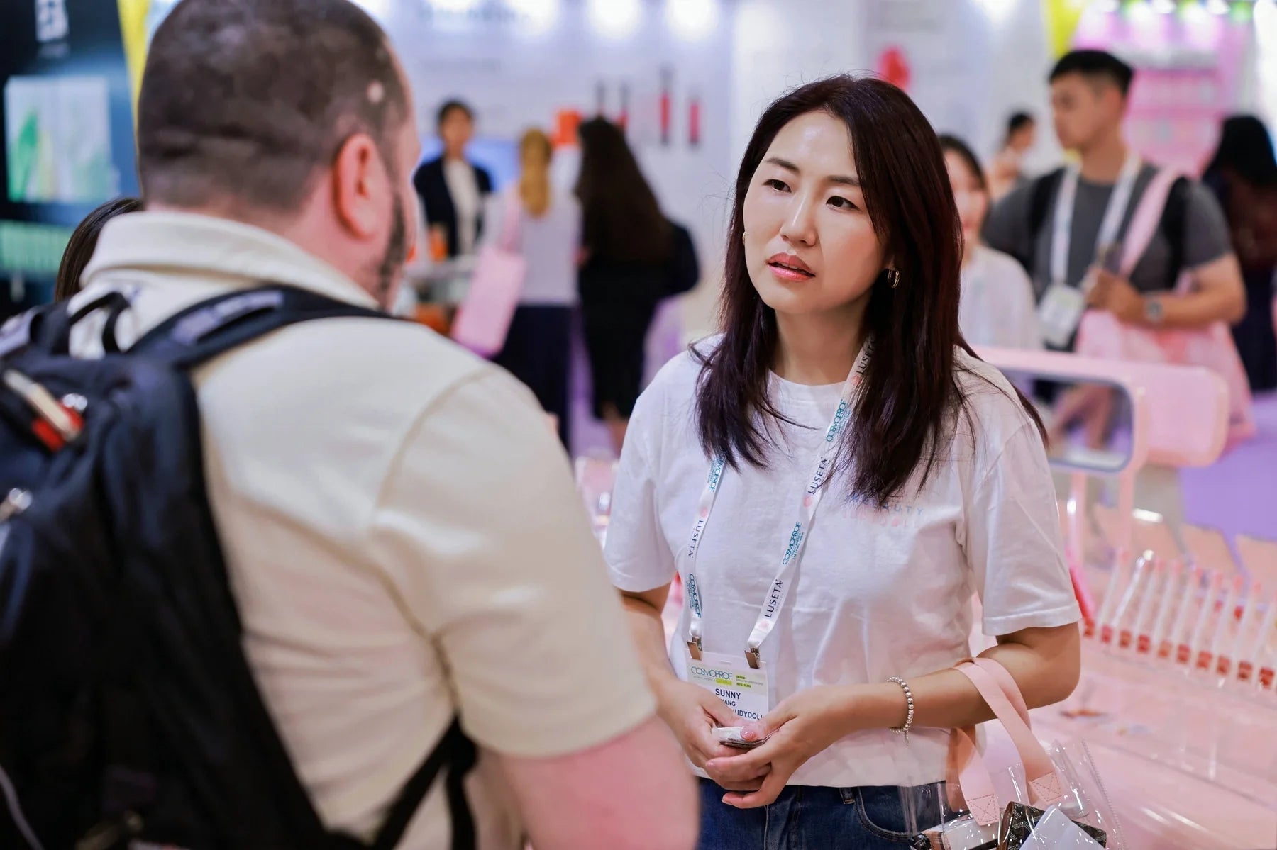 Another face-to-face exchange on the show floor, with the products and displays close by.