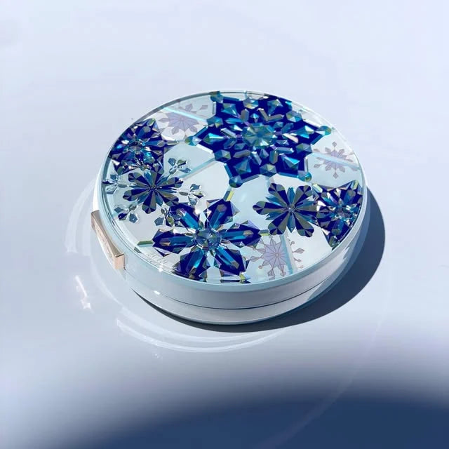 A blue floral makeup compact