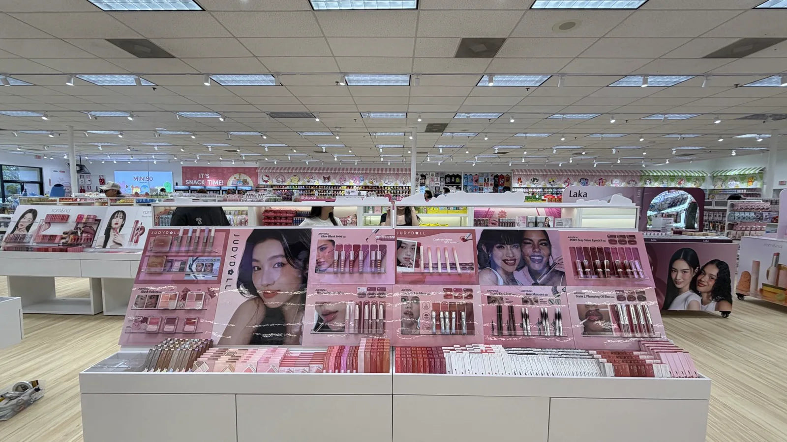 Beauty brand displays on a MINISO store floor